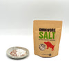 This photo has 1 -hand crafted, small, white and grey ceramic dish. + 1- 6 oz bag of  Omnivore SALT.